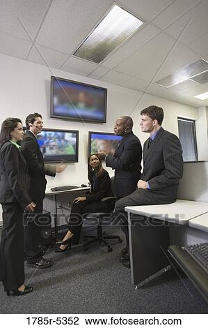 Business colleagues having a discussion in the office View Large Photo Image Stock Image - Business colleagues having a discussion in the office. Fotosearch