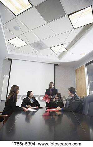 Business executives at a presentation in a formal conference room View Large Photo Image Picture - Business executives at a presentation in a formal conference room. Fotosearch