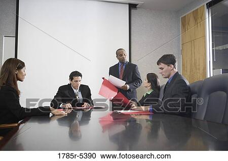 Business executives at a presentation in a formal conference room View Large Photo Image Stock Image - Business executives at a presentation in a formal conference room. Fotosearch