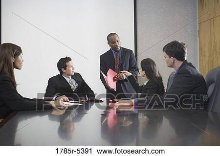 Business executives at a presentation in a formal conference room View Large Photo Image Stock Image - Business executives at a presentation in a formal conference room. Fotosearch