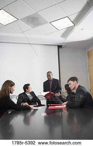 Business executives at a presentation in a formal conference room View Large Photo Image Stock Image - Business executives at a presentation in a formal conference room. Fotosearch