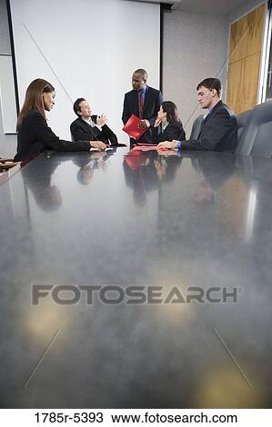 Business executives at a presentation in a formal conference room View Large Photo Image Stock Image - Business executives at a presentation in a formal conference room. Fotosearch