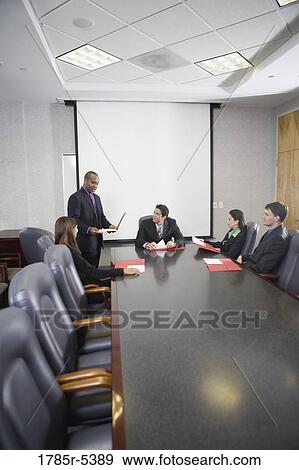 Business executives at a presentation in a formal conference room View Large Photo Image Stock Photo - Business executives at a presentation in a formal conference room. Fotosearch