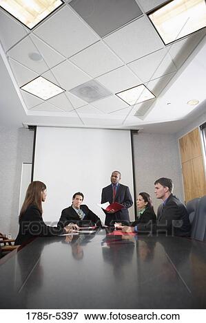 Business executives at a presentation in a formal conference room View Large Photo Image Stock Photo - Business executives at a presentation in a formal conference room. Fotosearch