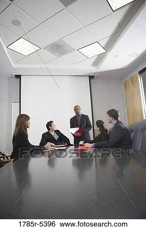 Business executives at a presentation in a formal conference room View Large Photo Image Stock Photograph - Business executives at a presentation in a formal conference room. Fotosearch