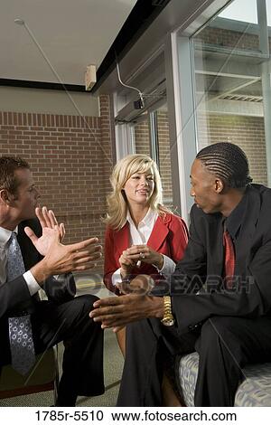 Business executives having discussion View Large Photo Image Stock Image - Business executives having discussion. Fotosearch