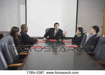 Business executives in a meeting in a formal conference room View Large Photo Image Stock Photo - Business executives in a meeting in a formal conference room. Fotosearch