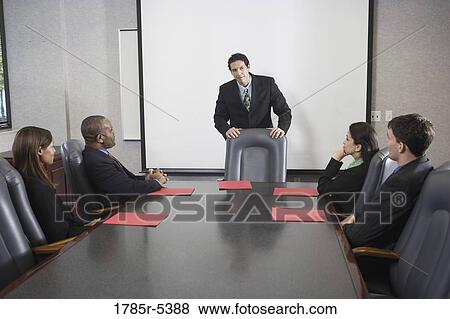 Stock Photo - Business executives in a meeting in a formal conference room. Fotosearch
