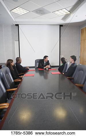 Business executives in a meeting in a formal conference room View Large Photo Image Stock Photograph - Business executives in a meeting in a formal conference room. Fotosearch