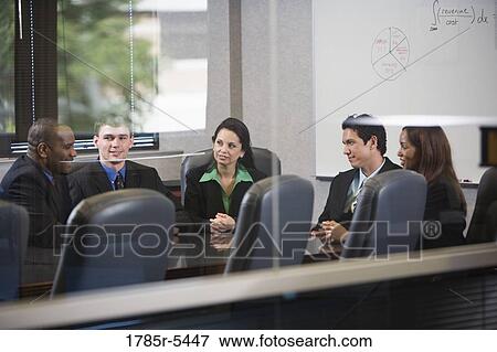Business executives meeting in a conference room viewed through a window View Large Photo Image Stock Photo - Business executives meeting in a conference room viewed through a window. Fotosearch
