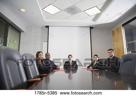 Business executives sitting together in a formal conference room View Large Photo Image Stock Photography - Business executives sitting together in a formal conference room. Fotosearch