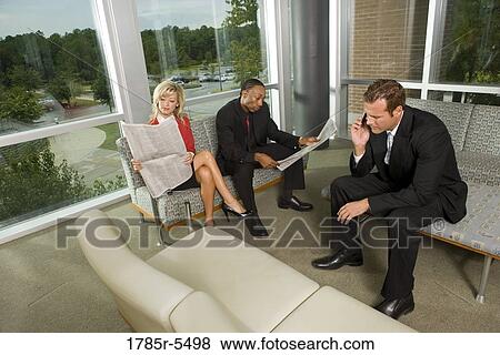 Business executives waiting in reception area View Large Photo Image Stock Photo - Business executives waiting in reception area. Fotosearch
