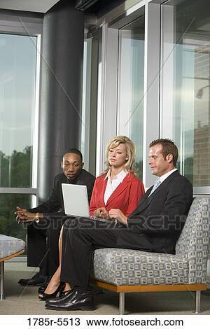 Business executives working together on laptop View Large Photo Image Stock Image - Business executives working together on laptop. Fotosearch
