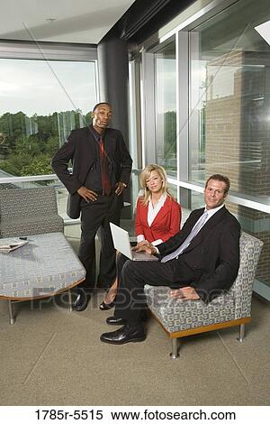 Stock Photography - Business executives working together on laptop. Fotosearch