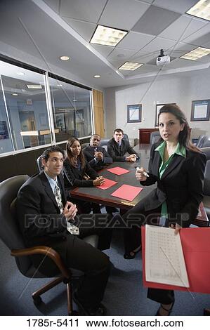Business men and women at a presentation in a formal conference room View Large Photo Image Stock Image - Business men and women at a presentation in a formal conference room. Fotosearch