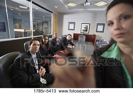 Business men and women at a presentation in a formal conference room View Large Photo Image Stock Image - Business men and women at a presentation in a formal conference room. Fotosearch