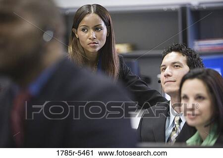Business men and women watching and listening attentively View Large Photo Image Stock Image - Business men and women watching and listening attentively. Fotosearch