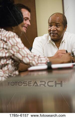 Stock Photo - Business people meeting in conference room. Fotosearch