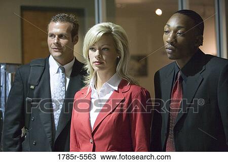 Business people standing in an office hallway View Large Photo Image Stock Image - Business people standing in an office hallway. Fotosearch