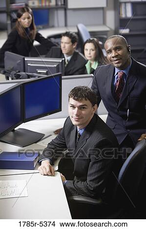 Business people working in a busy office View Large Photo Image Picture - Business people working in a busy office. Fotosearch