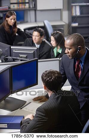 Business people working in a busy office View Large Photo Image Stock Image - Business people working in a busy office. Fotosearch