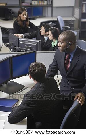 Business people working in a busy office View Large Photo Image Stock Photo - Business people working in a busy office. Fotosearch