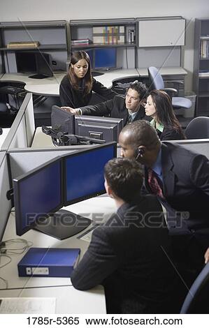 Stock Photography - Business people working in a busy office. Fotosearch