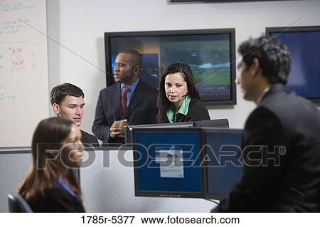 Business people working in an office View Large Photo Image Stock Photo - Business people working in an office. Fotosearch