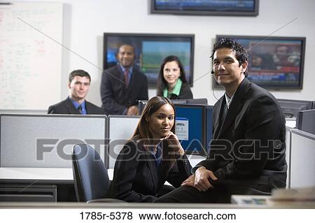 Business people working in an office View Large Photo Image Stock Photo - Business people working in an office. Fotosearch