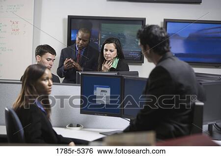 Stock Photograph - Business people working in an office. Fotosearch