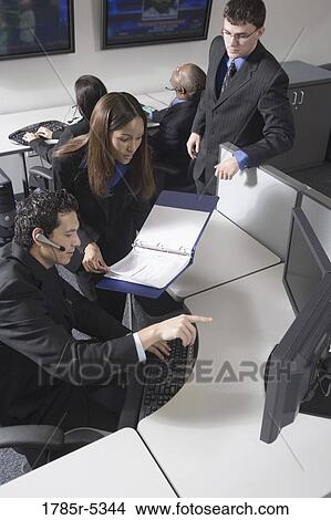 Business people working together in a busy office View Large Photo Image Picture - Business people working together in a busy office. Fotosearch