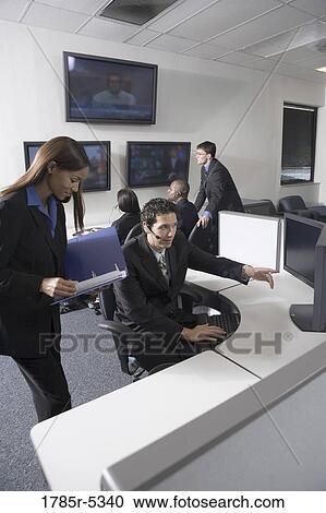 Business people working together in a busy office View Large Photo Image Stock Image - Business people working together in a busy office. Fotosearch