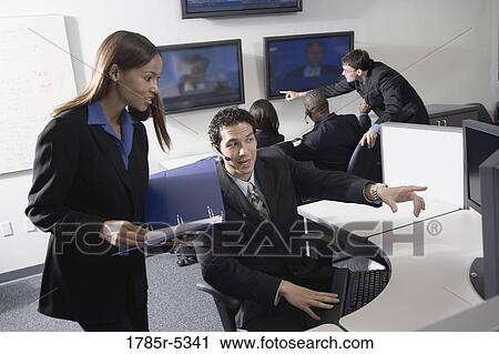 Business people working together in a busy office View Large Photo Image Stock Image - Business people working together in a busy office. Fotosearch