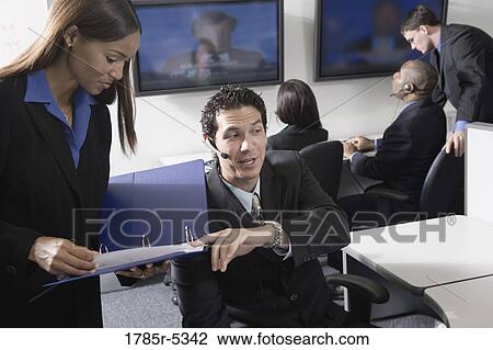 Business people working together in a busy office View Large Photo Image Stock Image - Business people working together in a busy office. Fotosearch