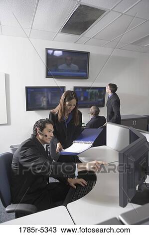 Business people working together in a busy office View Large Photo Image Stock Image - Business people working together in a busy office. Fotosearch