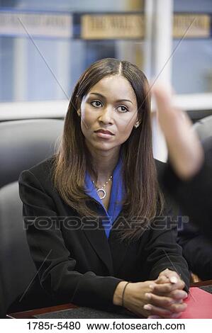 Business woman watching and listening attentively in a meeting View Large Photo Image Stock Image - Business woman watching and listening attentively in a meeting. Fotosearch