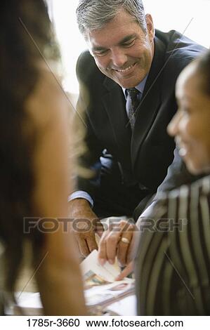Businessman in a meeting with women colleagues View Large Photo Image Stock Image - Businessman in a meeting with women colleagues. Fotosearch