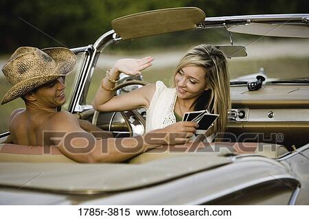 Cheerful and playful couple sitting in antique convertible car View Large Photo Image Stock Photography - Cheerful and playful couple sitting in antique convertible car. Fotosearch