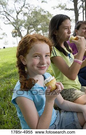Children and their teacher eatingcupcakes at a park View Large Photo Image Stock Photography - Children and their teacher eatingcupcakes at a park. Fotosearch