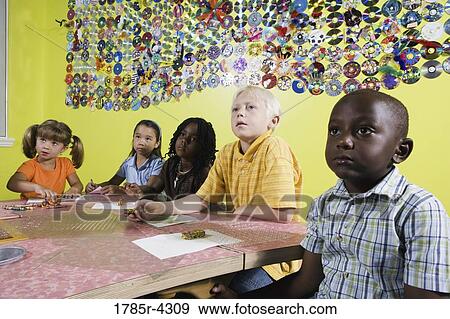 Children drawing and paying attention in art class View Large Photo Image Stock Photo - Children drawing and paying attention in art class. Fotosearch