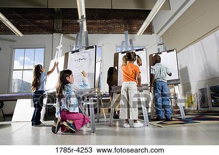 Children drawing on easels in art class View Large Photo Image Stock Image - Children drawing on easels in art class. Fotosearch