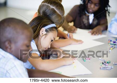children drawing with crayons around a table View Large Photo Image Stock Image - children drawing with crayons around a table. Fotosearch