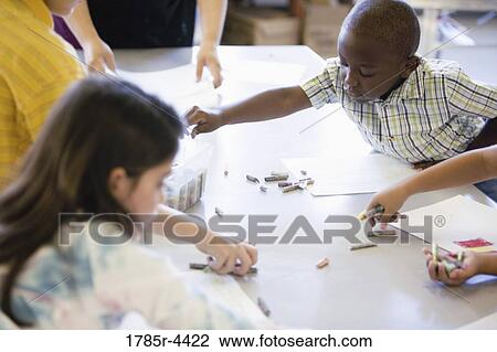 children drawing with crayons around a table View Large Photo Image Stock Image - children drawing with crayons around a table. Fotosearch