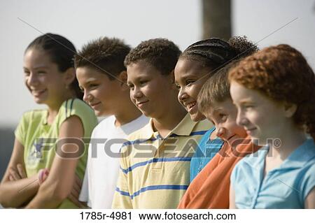 Children outdoors standing side by side View Large Photo Image Stock Image - Children outdoors standing side by side. Fotosearch