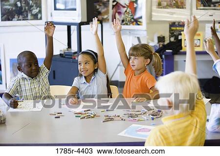 Children raising hands in art class View Large Photo Image Stock Image - Children raising hands in art class. Fotosearch