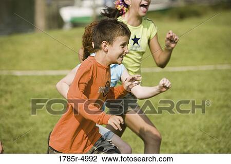 Children running and having fun outdoors View Large Photo Image Stock Image - Children running and having fun outdoors. Fotosearch