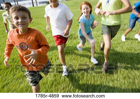 Children running towards the viewer View Large Photo Image Stock Photo - Children running towards the viewer. Fotosearch