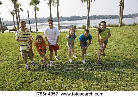 Children standing abreast at a park, getting set to race View Large Photo Image Stock Photo - Children standing abreast at a park, getting set to race. Fotosearch