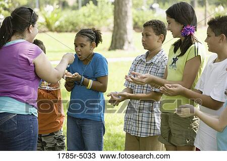 Stock Image - Children waiting eagerly in line. Fotosearch