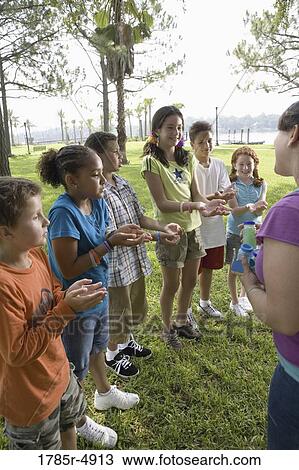 Children waiting in line holding out hands View Large Photo Image Stock Image - Children waiting in line holding out hands. Fotosearch